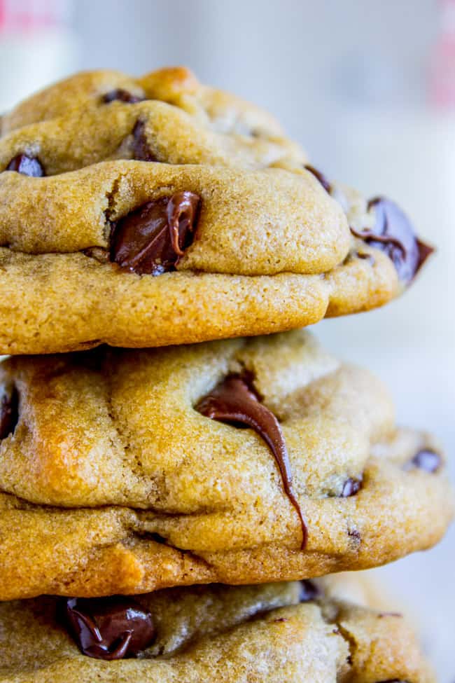 a stack of chocolate chip cookies with melting chocolate chips.