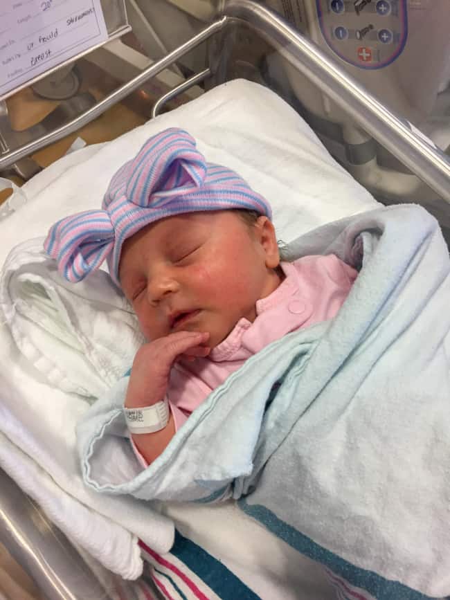 newborn baby girl in a hospital crib.