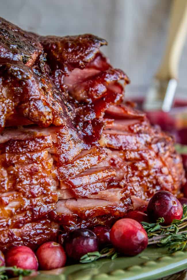 Side shot of glazed spiral ham with cranberries