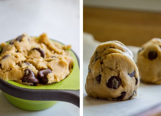 chocolate chip cookie dough in a measuring cup, balls of chocolate chip cookie dough on parchment paper.