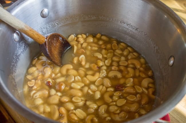 Peanuts floating in glaze showing how to make christmas chex mix recipe 