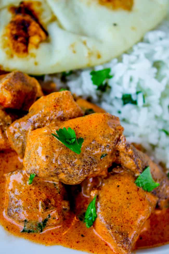 chicken tikka masala with rice, naan, and cilantro.