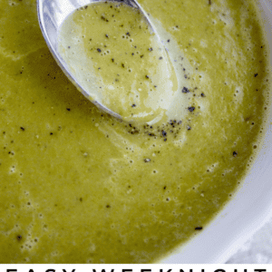 a bowl of pea soup with a spoon in it.