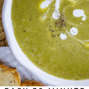 a bowl of pea soup with cream and fresh pepper on top.