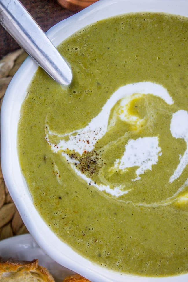 a bowl of homemade pea soup with cream and fresh pepper.