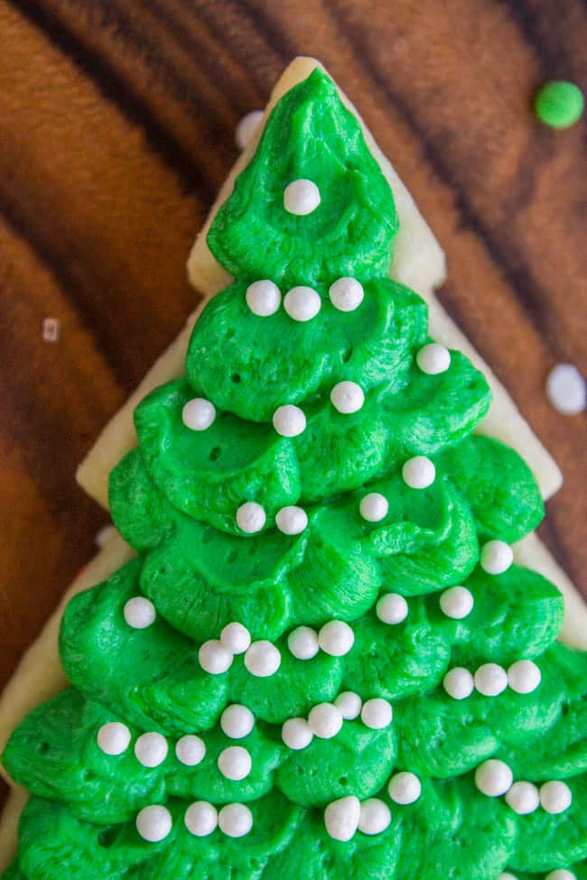 Green sugar cookie frosting on top of a Christmas tree shaped cookie