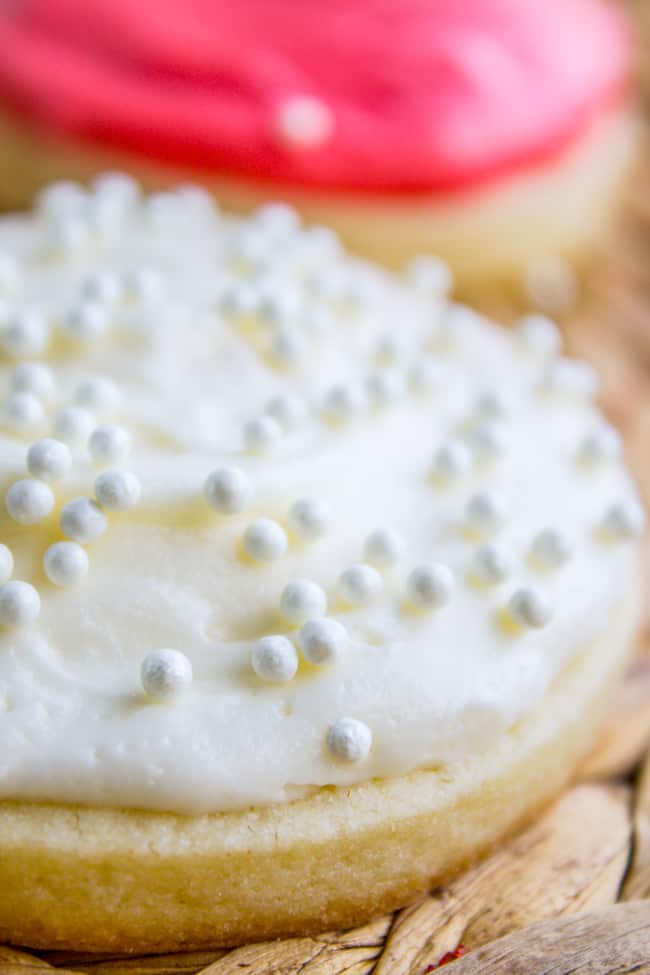 Sugar cookie frosting recipe in white on a cookie with sprinkles