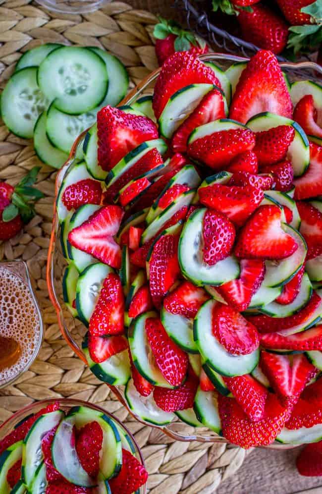 Strawberry Cucumber Salad with Honey Balsamic Dressing in pink glass bowl on placemat.