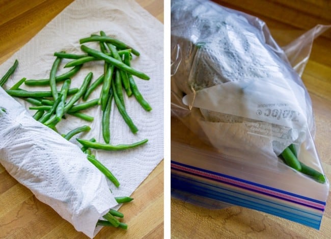 drying blanched green beans with a paper towel, storing them in a plastic bag.