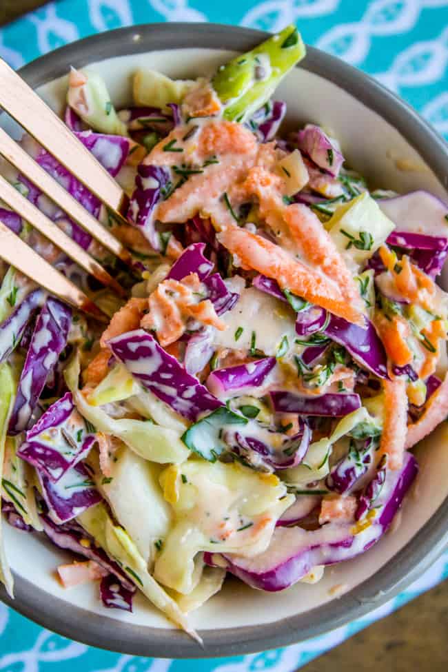 a fork dipping into a bowl of fresh homemade coleslaw.