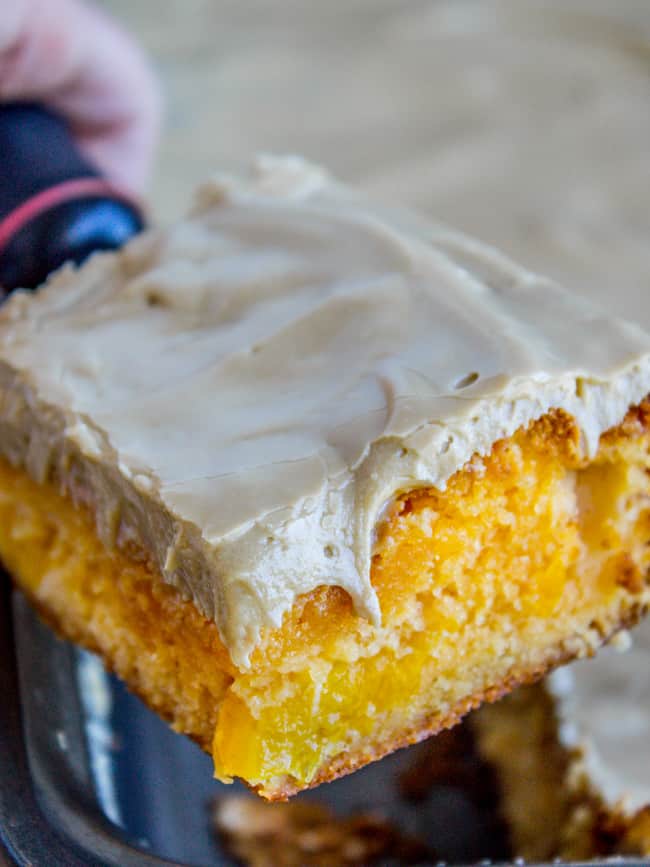 a slice of peach cake with brown sugar frosting.