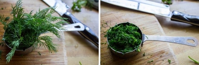 measuring fresh chopped dill into a measuring cup. 