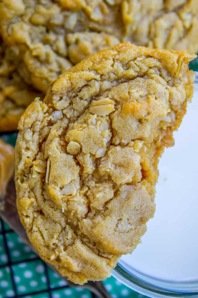 soft and chewy peanut butter oatmeal cookies with one broken cookie resting on a glass of milk. 