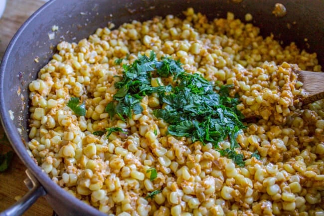 Adding cilantro to the Mexican Corn Dip