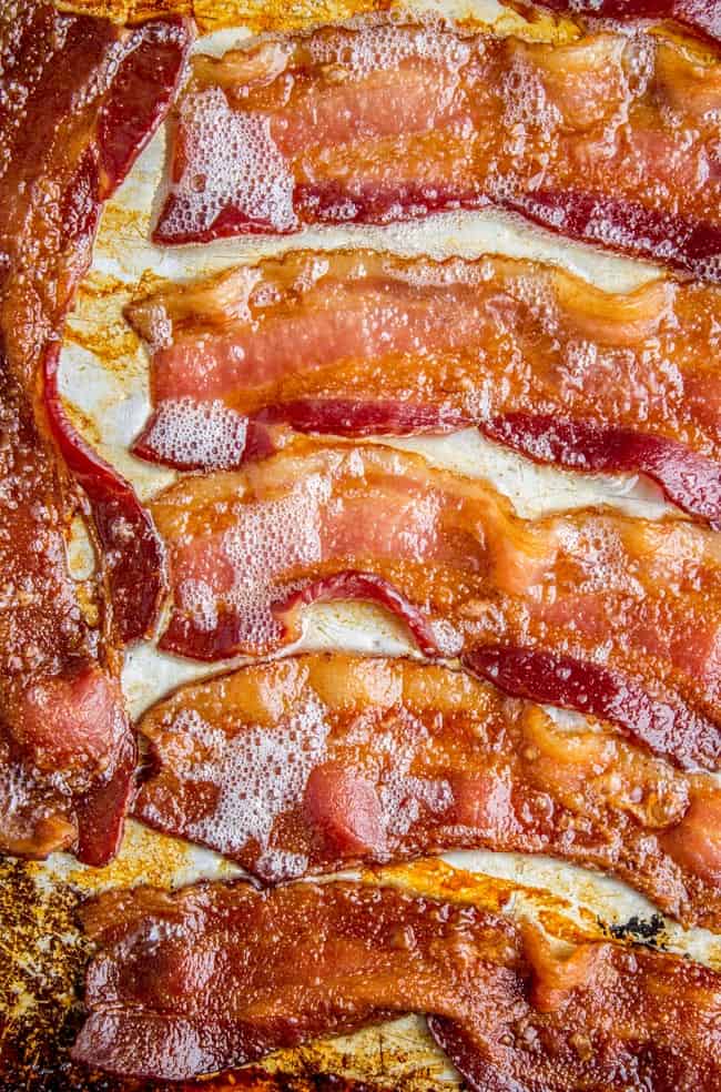 strips of crispy, sizzling bacon on a sheet pan.