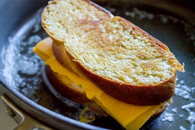 Grilled cheese sandwich cooking in frying pan