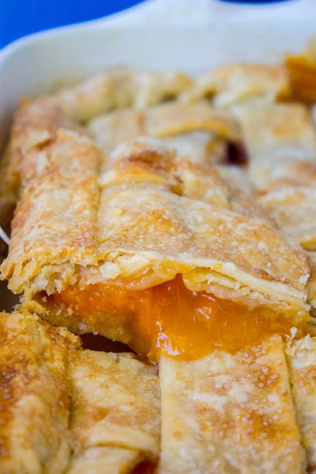 Lifting a piece of Peach Apricot Slab Pie from the pan.