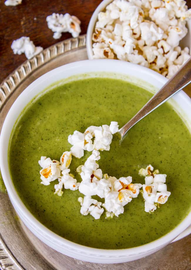 creamy zucchini soup with popcorn on top.