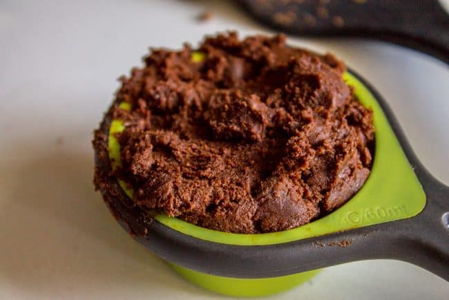 packed cookie dough in measuring cup.