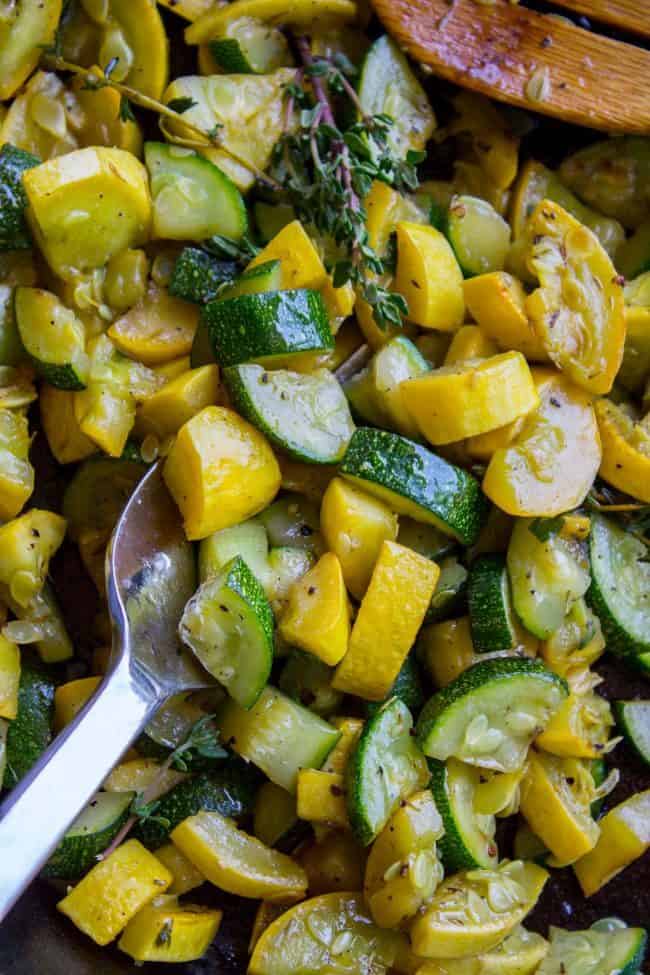 sauteed zucchini and squash with a metal spoon. 