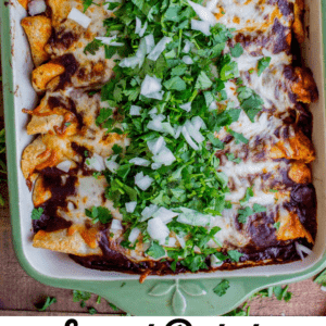 A casserole dish filled with sweet potato and black bean enchiladas, topped with melted cheese, chopped onions, and fresh cilantro. Decorative text below reads: Sweet Potato & Black Bean Enchiladas - a vegetarian favorite.