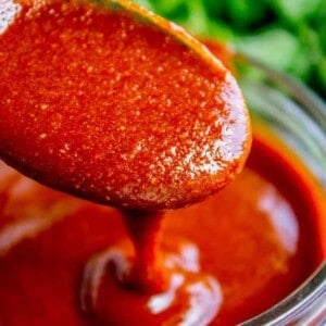 homemade enchilada sauce on a spoon.