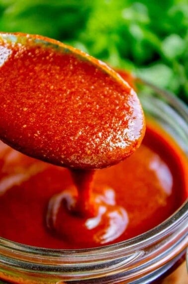 homemade enchilada sauce on a spoon.
