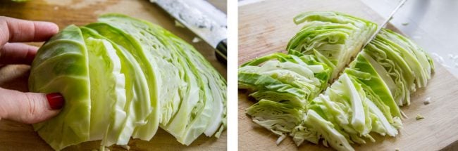 thinly slicing green cabbage on a wooden cutting board.