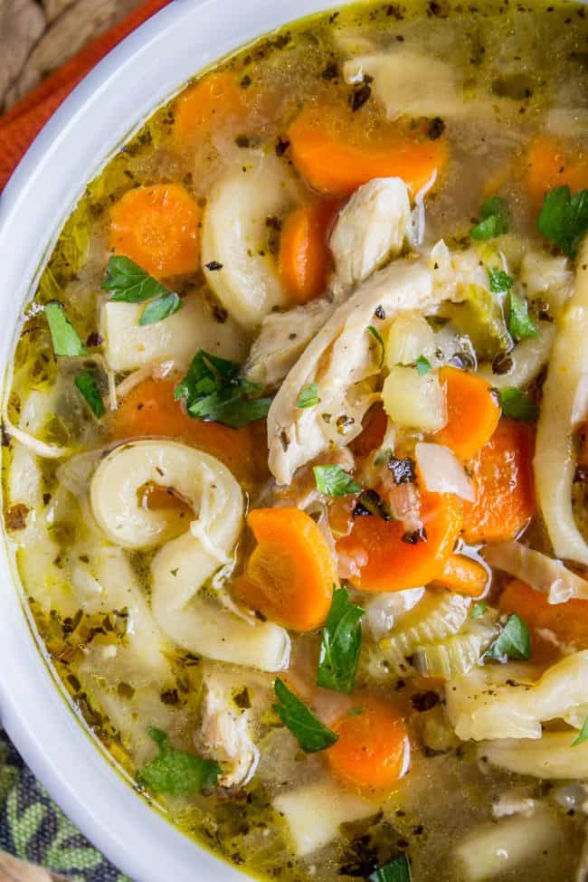 Chicken noodle soup in a white bowl with homemade noodles.