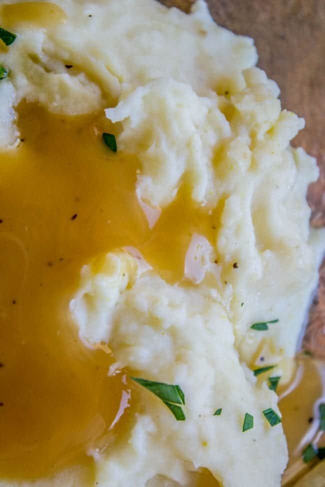 a pile of fluffy mashed potatoes with gravy on top.