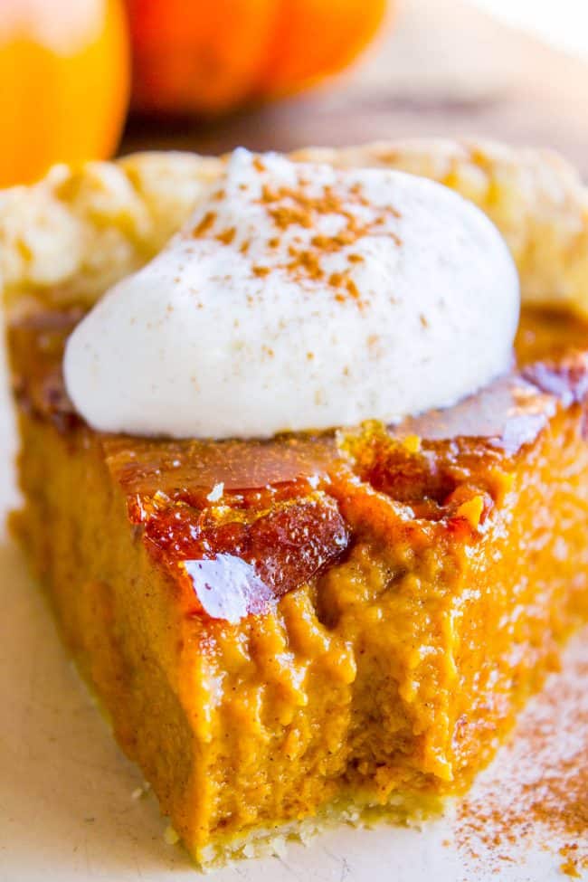 creamy pumpkin pie with creme brulee topping and fresh whipped cream. 