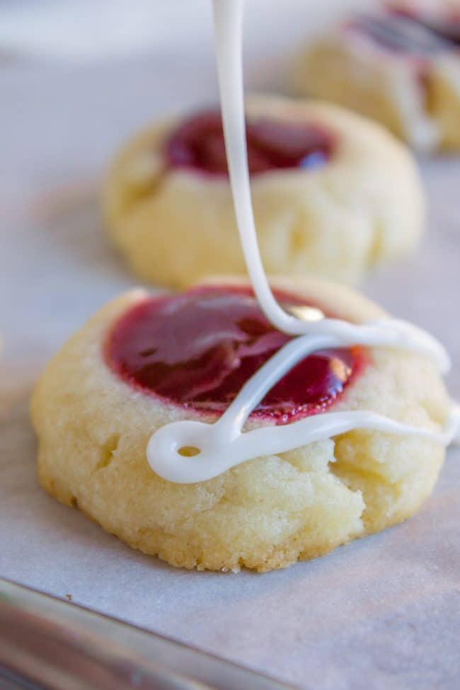 Drizzling glaze on a thumbprint cookie.