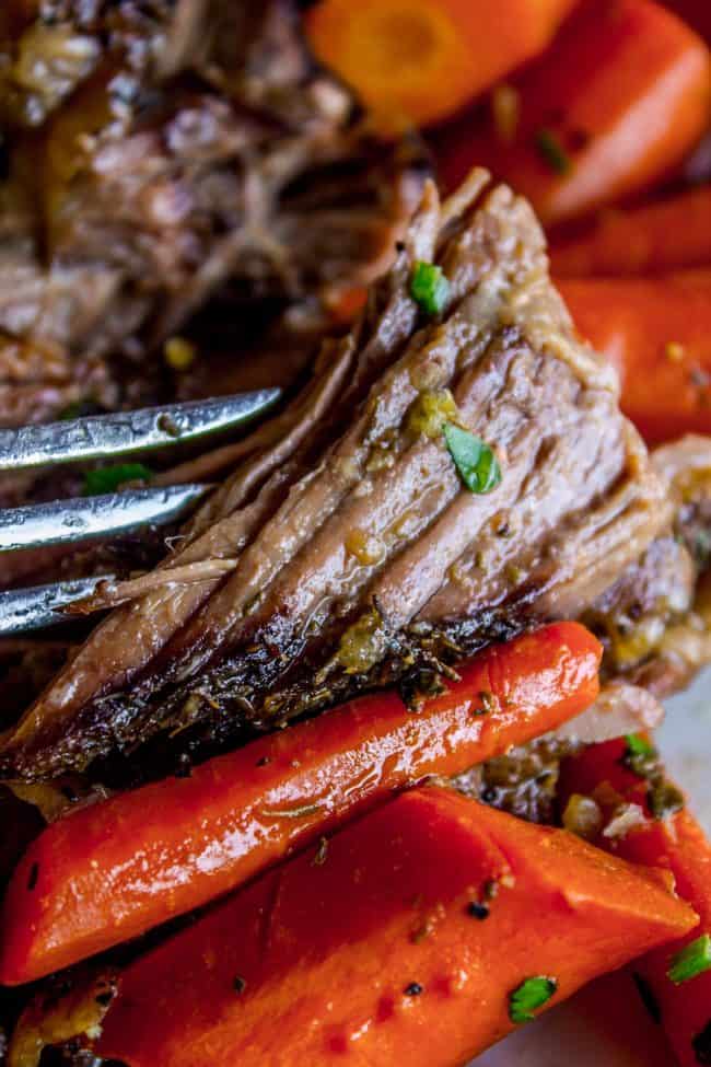 Easy Fall-Apart Pot Roast with Carrots (Slow Cooker) from The Food Charlatan. Super tender, juicy, fall-apart crock pot roast is not as hard as you think! This slow cooker recipe uses a few simple ingredients (one of them is patience) to make the most flavorful pot roast ever! #potroast #slowcooker #crockpot #roast #chuckroast #tender #juicy Juicy pot roast and carrots