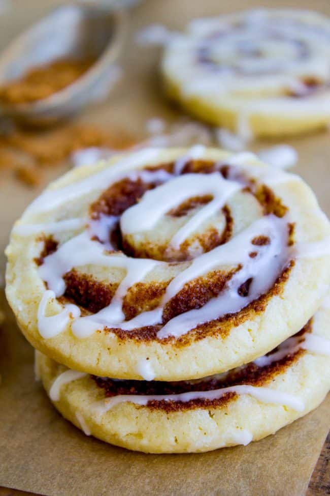 stack of cinnamon roll sugar cookies with powdered sugar glaze