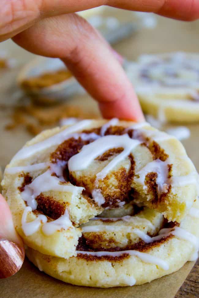 hand with cinnamon rolls sugar cookies with glaze