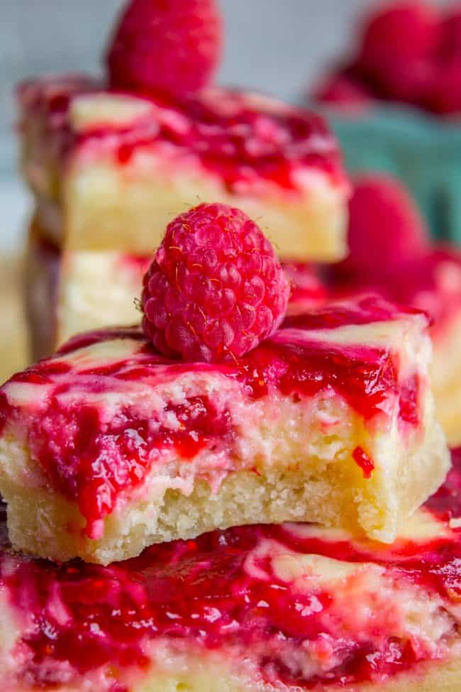 raspberry cheesecake bars with fresh raspberries. 