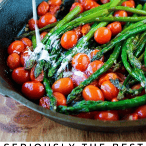 A skillet filled with sautéed asparagus and cherry tomatoes, with a stream of cream being poured over the vegetables. Text below reads: Seriously Good Asparagus & Cherry Tomatoes - The Food Charlatan.