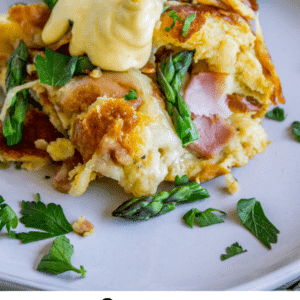hollandaise sauce being poured on a slice of savory bread pudding.