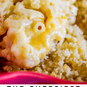 A close-up of creamy macaroni and cheese with a golden breadcrumb topping being scooped, featuring bold text below: The Cheesiest Macaroni and Cheese - The Food Charlatan, highlighting irresistible comfort food.