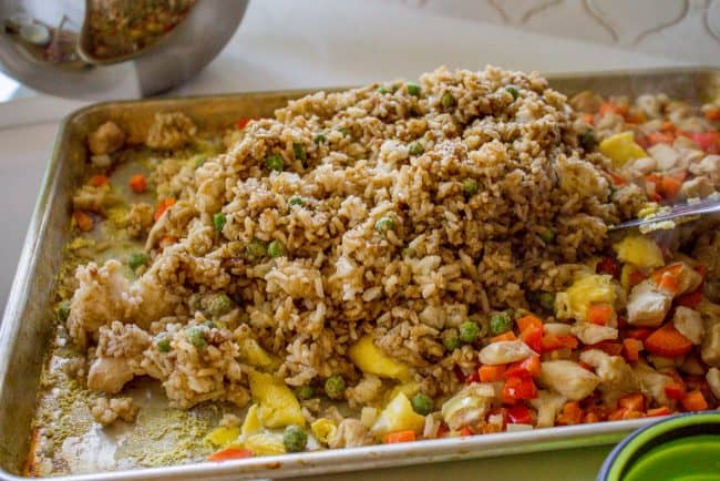 Spreading rice on top of veggies in pan