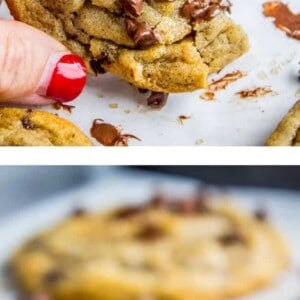 A close-up of a gooey chocolate chip cookie with melted chocolate chips, partially eaten, held by a hand with red nail polish; more of the best chocolate chip cookies are shown in the background and foreground.
