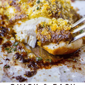 baked pesto chicken with a fork removing a bite.