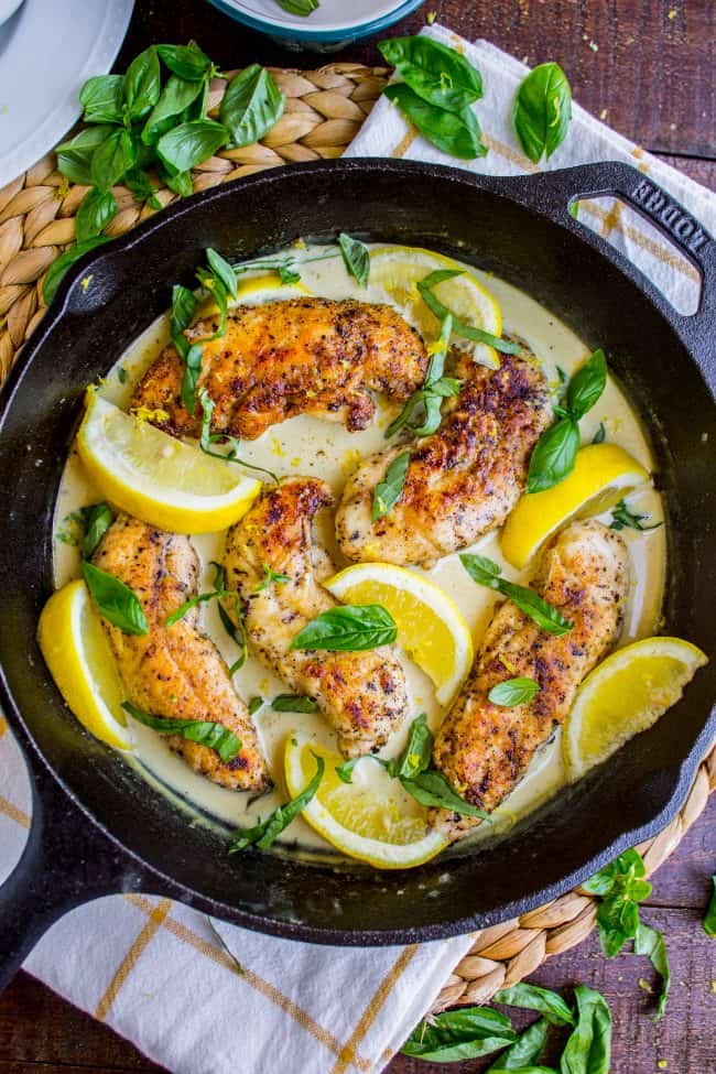 creamy lemon chicken with fresh basil in a cast iron skillet.