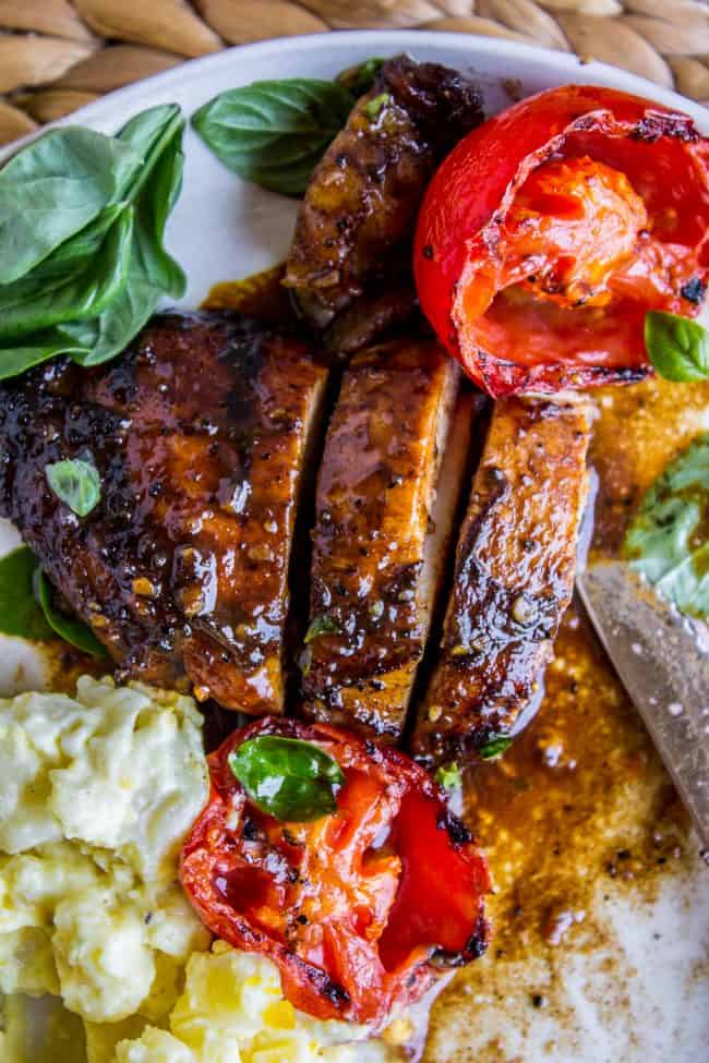 sliced grilled chicken with potato salad and grilled veggies. 