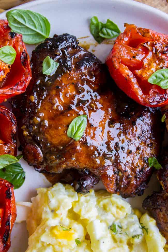 grilled chicken with veggies on a white plate. 