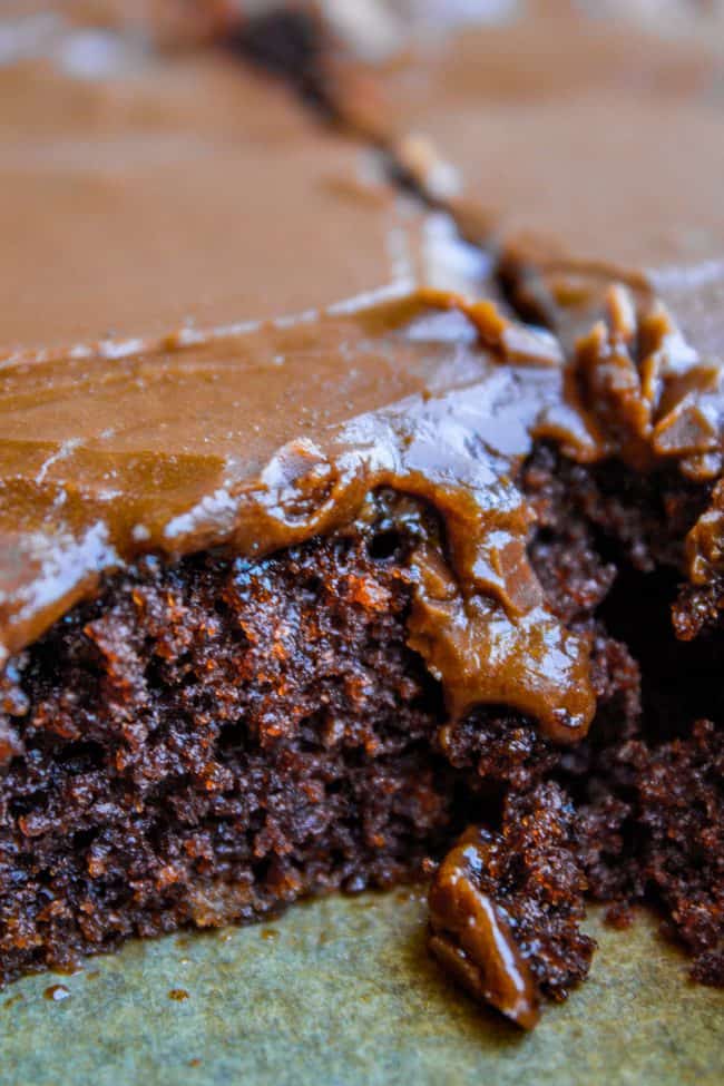 big pieces of texas sheet cake on a baking sheet.