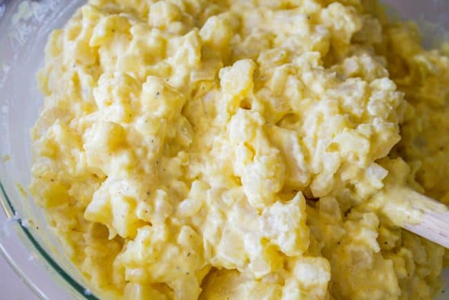 mixing up homemade potato salad.