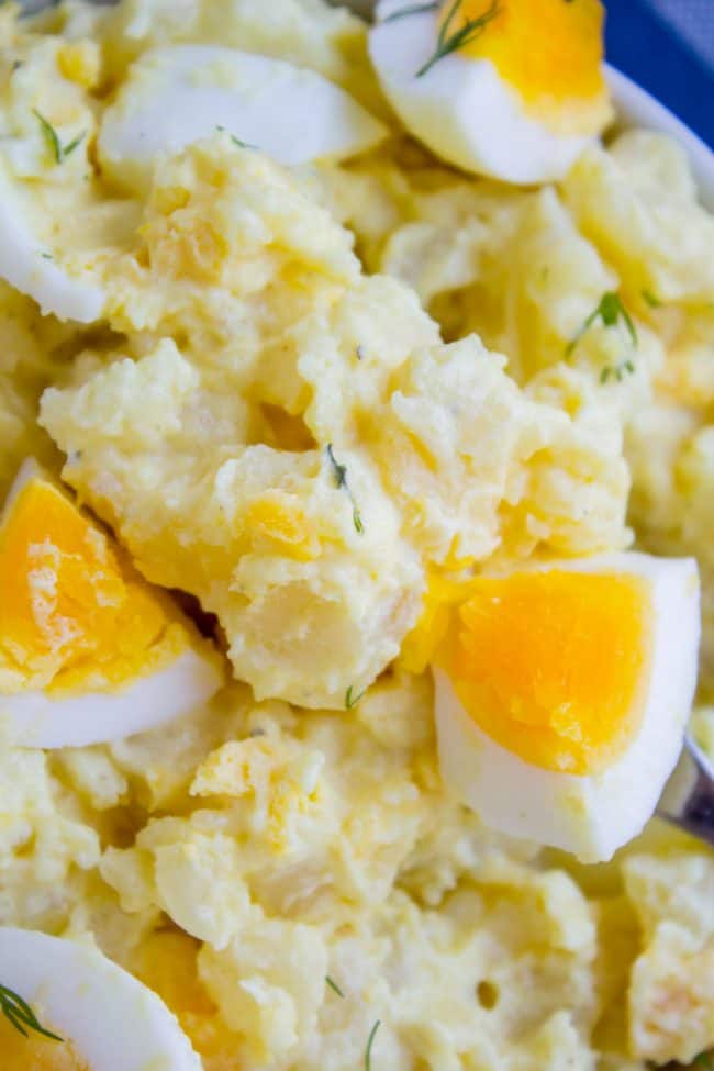 close up shot of potato salad with hard boiled eggs. 