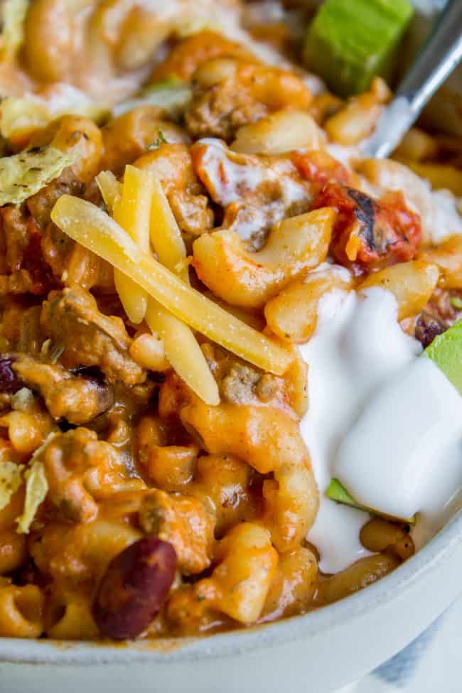 Chili mac and cheese topped with cheddar, sour cream, and avocado. 