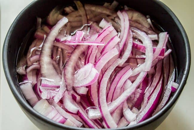 soaking red onions in water.